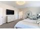 Bright bedroom featuring modern vanity, television and large bed at 18441 New London Ave, Land O Lakes, FL 34638
