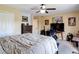Comfortable bedroom with a ceiling fan, neutral walls, a plush bed, and an entertainment setup at 18441 New London Ave, Land O Lakes, FL 34638