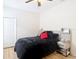Cozy bedroom features wood-look floors, neutral walls, and minimalist decor at 18441 New London Ave, Land O Lakes, FL 34638