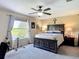 A well-lit bedroom with a large window, carpeted floors, and a ceiling fan, creating a relaxing atmosphere at 18441 New London Ave, Land O Lakes, FL 34638