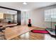 Bonus room features laminate flooring, a workout space and a large mirror at 18441 New London Ave, Land O Lakes, FL 34638
