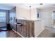 Bonus room featuring wood accent wall, laminate floors, and window at 18441 New London Ave, Land O Lakes, FL 34638