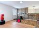 Bonus room featuring laminate flooring, a workout space, and bar at 18441 New London Ave, Land O Lakes, FL 34638