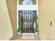 Inviting entryway featuring a black front door flanked by decorative spiral topiaries at 18441 New London Ave, Land O Lakes, FL 34638