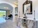 Elegant foyer with marble console, modern art, and view to a spacious living area at 18441 New London Ave, Land O Lakes, FL 34638