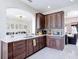 Contemporary kitchen with custom cabinets, marble countertops, stainless steel appliances and view into breakfast nook at 18441 New London Ave, Land O Lakes, FL 34638