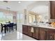 Open-concept kitchen and dining area with a large window, modern light fixture and light countertops at 18441 New London Ave, Land O Lakes, FL 34638