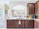 Kitchen featuring custom wood cabinetry, marble countertops, stainless steel appliances, and a decorative tile backsplash at 18441 New London Ave, Land O Lakes, FL 34638