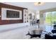 Living room boasts custom media wall, tile flooring, and expansive sliding doors to outdoor space at 18441 New London Ave, Land O Lakes, FL 34638