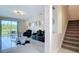 Bright living room with tile floors, home theater seating, and sliding glass doors to the backyard at 18441 New London Ave, Land O Lakes, FL 34638