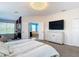A spacious primary bedroom featuring carpeted floors, a crystal chandelier, and an ensuite bathroom at 18441 New London Ave, Land O Lakes, FL 34638