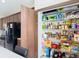 Spacious pantry with wood-look door, wire shelving, and plenty of storage for food and household items at 18441 New London Ave, Land O Lakes, FL 34638