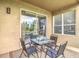 Outdoor patio with table, chairs, and sliding door entrance to natural light with window at 18441 New London Ave, Land O Lakes, FL 34638