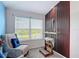 Comfortable sitting area with neutral chair, and large windows at 18441 New London Ave, Land O Lakes, FL 34638