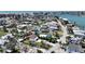Wide aerial shot showcases a coastal neighborhood with waterfront access and diverse home styles at 13116 Boca Ciega Ave, Madeira Beach, FL 33708