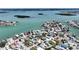 Panoramic aerial view of a coastal community near a bay with docks and boats at 13116 Boca Ciega Ave, Madeira Beach, FL 33708