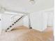 Spacious basement with wood-look flooring, stairs, and bright, white walls at 13116 Boca Ciega Ave, Madeira Beach, FL 33708