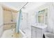 Well-lit bathroom with a soaking tub, walk-in shower, vanity, and a decorative mirror at 13116 Boca Ciega Ave, Madeira Beach, FL 33708
