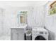 Bright bathroom featuring a vanity, toilet, washer/dryer, and modern finishes at 13116 Boca Ciega Ave, Madeira Beach, FL 33708