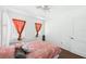 Bedroom features wood floors, large windows and a ceiling fan at 13116 Boca Ciega Ave, Madeira Beach, FL 33708