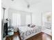 Bedroom featuring TV, ceiling fan and open bathroom at 13116 Boca Ciega Ave, Madeira Beach, FL 33708