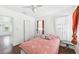 Bedroom featuring wood floors, closet, and an exterior view at 13116 Boca Ciega Ave, Madeira Beach, FL 33708