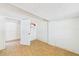 Bedroom with wood-look tile flooring, ample closet space, offering potential for customization and updates at 13116 Boca Ciega Ave, Madeira Beach, FL 33708