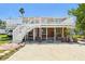 Two-story home with a large deck, great for enjoying outdoor living and relaxation at 13116 Boca Ciega Ave, Madeira Beach, FL 33708