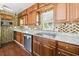Updated kitchen featuring granite countertops, stainless appliances, wood cabinets and mosaic backsplash at 13116 Boca Ciega Ave, Madeira Beach, FL 33708