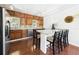 Bright kitchen features wood cabinets, stainless appliances, granite countertops, island with seating and wood floors at 13116 Boca Ciega Ave, Madeira Beach, FL 33708