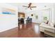 Living room with wood floors, white walls, ceiling fan, and furniture at 13116 Boca Ciega Ave, Madeira Beach, FL 33708