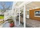 Under deck patio features tiled flooring, a brick accent wall, and convenient access to the house at 13116 Boca Ciega Ave, Madeira Beach, FL 33708