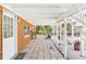 Covered patio with tiled flooring, brick accents, and ample space for outdoor activities at 13116 Boca Ciega Ave, Madeira Beach, FL 33708