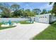 Backyard shows white gravel area for parking & fire pit area. A white fence surrounds the yard at 418 40Th S Ave, St Petersburg, FL 33705