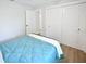 Minimalist bedroom design with wood-look floors, bright white walls, and closet at 418 40Th S Ave, St Petersburg, FL 33705