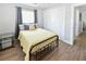 Well-lit bedroom featuring wood-look flooring, a double closet, and modern decor at 418 40Th S Ave, St Petersburg, FL 33705