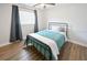 Cozy bedroom with wood-look flooring, natural light, and minimalist decor at 418 40Th S Ave, St Petersburg, FL 33705