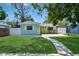 Charming home with a well-manicured lawn and inviting yellow door for a warm, sunny entrance at 418 40Th S Ave, St Petersburg, FL 33705