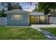 Exterior view of home with pathway leading to a covered entryway with chairs for relaxing at 418 40Th S Ave, St Petersburg, FL 33705