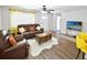Bright living room with hardwood floors and comfortable leather seating, flowing to an open-concept kitchen at 418 40Th S Ave, St Petersburg, FL 33705
