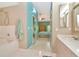 Bathroom leading into primary bedroom with dual vanity and large soaking tub at 1188 Royal Blvd, Palm Harbor, FL 34684