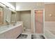 Spacious bathroom featuring a double vanity, walk-in shower, and a separate bathtub at 1188 Royal Blvd, Palm Harbor, FL 34684
