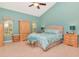 Bright bedroom featuring a light color scheme, windows, ceiling fan, and tile floors at 1188 Royal Blvd, Palm Harbor, FL 34684