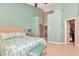 Large bedroom with ceiling fan and a doorway leading to another area at 1188 Royal Blvd, Palm Harbor, FL 34684