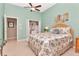 Serene bedroom with neutral tiled floors, a ceiling fan, and an attached closet at 1188 Royal Blvd, Palm Harbor, FL 34684