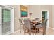 Cozy dining area featuring a wood table, seating for six, and natural light from the sliding glass door at 1188 Royal Blvd, Palm Harbor, FL 34684