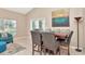 Cozy dining area with stylish table and chairs, and natural light from patio doors at 1188 Royal Blvd, Palm Harbor, FL 34684