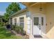 Charming home featuring a decorative front door, well-manicured landscaping, and a welcoming entrance at 1188 Royal Blvd, Palm Harbor, FL 34684