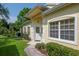 Inviting front entrance with decorative door, sidelight windows, and manicured landscaping at 1188 Royal Blvd, Palm Harbor, FL 34684