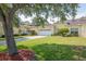 Charming single-story home with well-manicured lawn, mature tree, and a two-car garage at 1188 Royal Blvd, Palm Harbor, FL 34684
